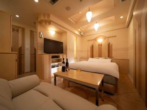 a hotel room with a bed and a couch at ホテルレジェンドプラス-Adult only in Kyoto