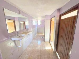 a bathroom with two sinks and two mirrors at Gite Megdaz in Megdaz