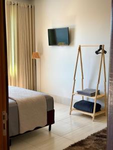 a bedroom with a bed and a tv on a wall at Rancho Palmeira Jardim in Formosa +33 photos