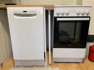 a white oven sitting next to a counter at Vuonamo - Summer cottage in Keitele +31 photos