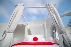 a red ball sitting on top of a bed at Barn bubble in Maidstone