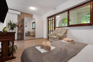 a bedroom with a bed with two towels on it at Apartments Harmony of Five in Makarska