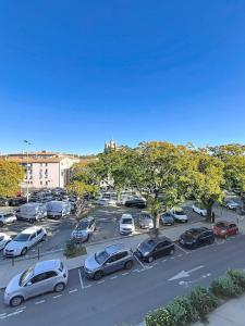 a parking lot with many cars parked in it at Le poli - 6 pers - Centre - vue sur la cathédrale in Narbonne