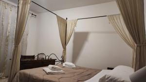 a bedroom with a bed with two towels on it at Il Rifugio in Celano