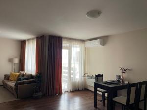 a living room with a couch and a table and a window at Comfortable and affordable big studio in Bŭnzareto