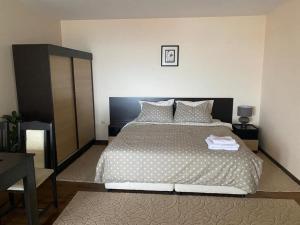 a bedroom with a large bed with a black headboard at Comfortable and affordable big studio in Bŭnzareto