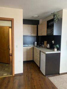 a kitchen with a sink and a counter top at Comfortable and affordable big studio in Bŭnzareto +5 photos