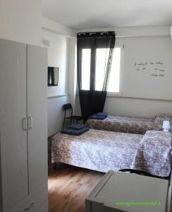 Un dormitorio con dos camas y una ventana en Agrimar, en Magliano Romano