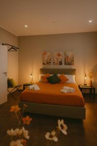 a bedroom with a bed with two towels on it at Marine Case Vacanze in Palermo