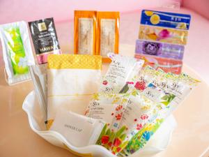 a white bowl filled with different types of candy at ホテルレジェンドプラス-Adult only in Kyoto