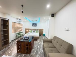 a living room with a couch and a bed at Marhaba plaza in Kozhikode