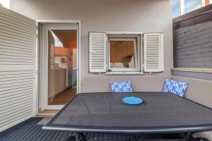 a patio table with a blue plate on it at Kuca za Odmor Ena in Jadranovo