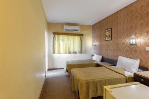 a hotel room with two beds and a window at St George Hotel Cairo in Cairo