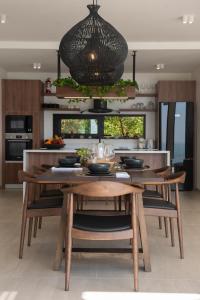 a kitchen with a table and a dining room at Sea Breeze Villa in Taling Ngam Beach
