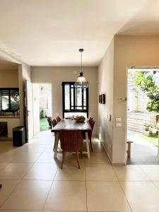 a dining room with a table and chairs at Garden apartment in Ramat HaSharon in Ramat Hash Sharon