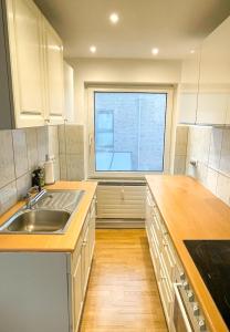eine Küche mit Spüle und Fenster in der Unterkunft 44 - 5 Modern appartement voor 6 personen in Weener + 9 Fotos
