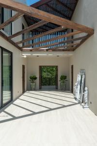 an empty patio with a wooden ceiling and windows at Sea Breeze Villa in Amphoe Koh Samui