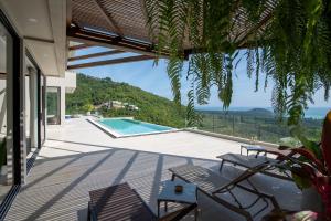 a house with a view of a swimming pool at Sea Breeze Villa in Taling Ngam Beach