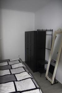 una camera da letto con uno specchio e un mobiletto nero di House Villa Butterfly a São Roque do Faial