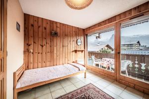 En eller flere senge i et værelse på Appartement Edelweiss - 7 personnes