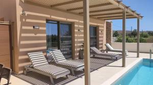 eine Terrasse mit Stühlen und einem Swimmingpool in der Unterkunft IRINI. seaview - beach - pool - privacy in Tympáki