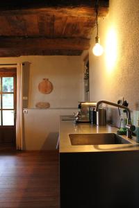 a kitchen with a sink and a counter top at Cascina Manzoni in Bossolasco