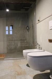 a bathroom with a tub and a toilet and a shower at Cascina Manzoni in Bossolasco +7 photos