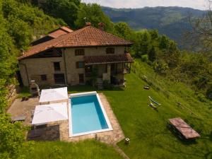 an aerial view of a house with a swimming pool at Cascina Manzoni in Bossolasco