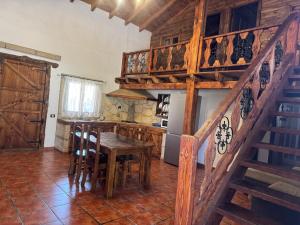a kitchen with a wooden staircase and a table at Casa Lolita in El Río