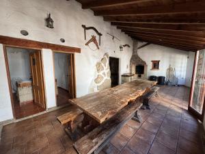 a room with a wooden table in a building at Casa granero 2 in El Río