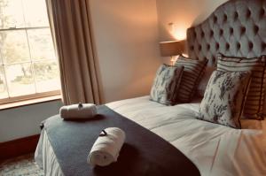 a bedroom with a bed with a roll of toilet paper on it at Red Ridge Mountain Lodge in Buffelskloof +52 photos