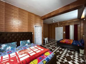ein Schlafzimmer mit 2 Betten und einem karierten Boden in der Unterkunft MountVista - A Homestay NH5 in Narkanda
