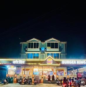 a building with people standing outside of it at night at Casa Sofiana hotel in Arpora