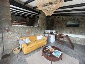 a living room with a couch and a table at suites en la montaña con propuesta de viñedo in La Cumbre +22 photos