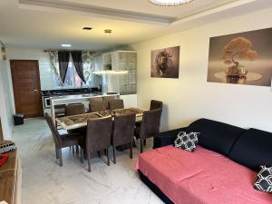 a living room with a table and a dining room at Casa completa para relaxar com a família in Passo De Torres
