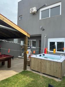 a backyard with a pool table and a house at Casa completa para relaxar com a família in Passo De Torres