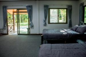 Ένα ή περισσότερα κρεβάτια σε δωμάτιο στο Baan Boon Homestay