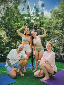 a group of people posing for a picture on yoga mats at Hostel Oryx Tulum in Tulum