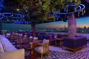 a bar with purple furniture and a view of the city at Hyatt Regency Dubai Creek Heights in Dubai