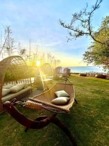 a wicker bench with pillows on the grass at Seaview Apartment with Pool at Lapu-Lapu City in Punta Engaño