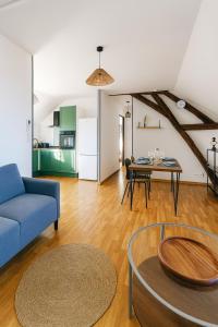 a living room with a blue couch and a table at Canal apartment ! Close to USON & Pont de Loire Nevers in Nevers