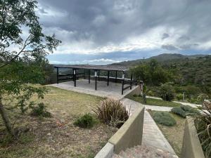 a pavilion with a view of a mountain at suites en la montaña con propuesta de viñedo in La Cumbre