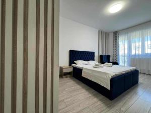 En eller flere senge i et værelse på Q Luxury Apartment