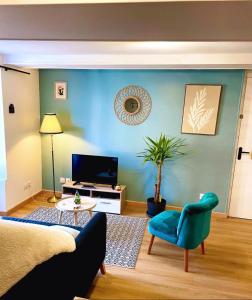 a living room with a blue wall at L'atelier du Charme Dole Centre in Dole +19 photos