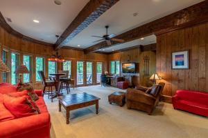 a living room with red furniture and a table at Amitola at Yonahlossee in Boone