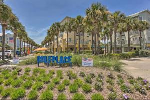 a sign in front of a building with palm trees at Coastal Dunes Escape in Santa Rosa Beach