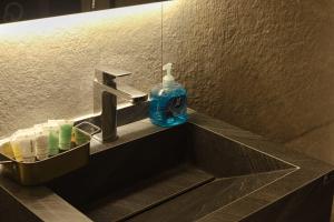 a bottle of soap sitting on a bathroom sink at اجنحة احسان in Medina +8 photos