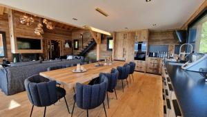 una sala da pranzo con un grande tavolo in legno e sedie di Chalet « Le 1712 » direct pistes a Les Angles Altre 16 foto