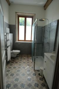 a bathroom with a shower toilet and a sink at Hippolyte House in Beaune