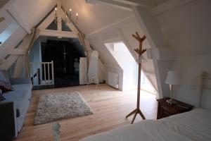 a bedroom with an attic with a bed and a rug at Hippolyte House in Beaune